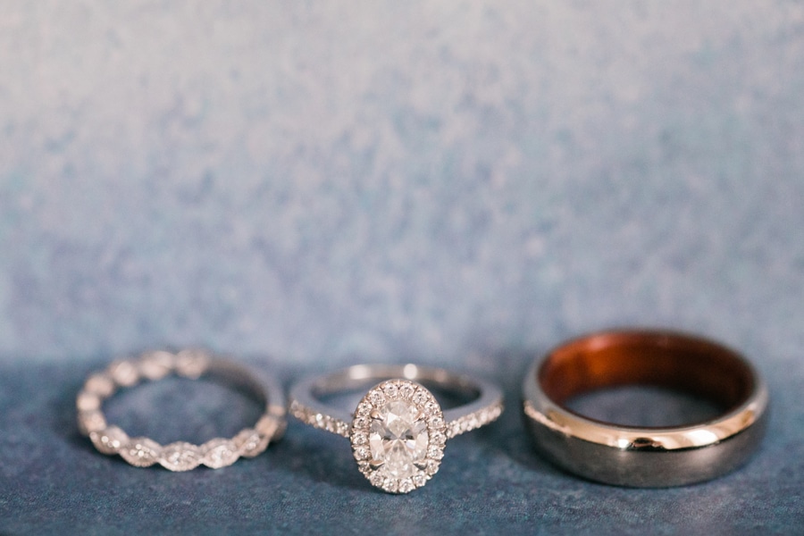 A closeup detail shot of the wedding bands and engagement ring.