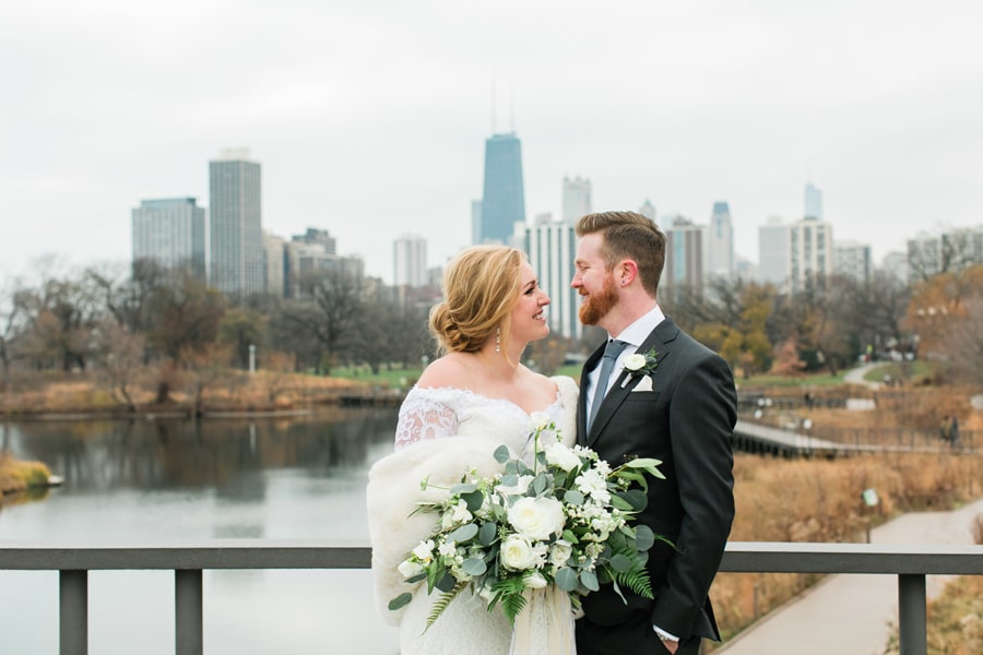 A bride and groom pose for a photo in Lincoln Park for their winter wedding in Chicago.