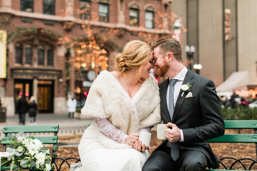 A bride and groom enjoy hot chocolate outside of the Historic Water Tower on their wedding day.
