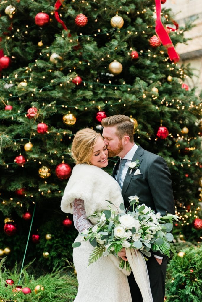A kiss in front of the Christmas tree in downtown Chicago.