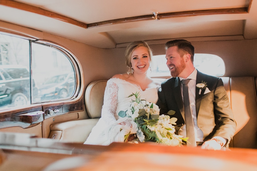 A vintage Rolls-Royce was the ultimate cozy portrait spot for this winter wedding in Chicago.