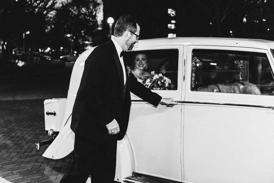 A bride pulls up to her wedding ceremony in a vintage Rolls-Royce.