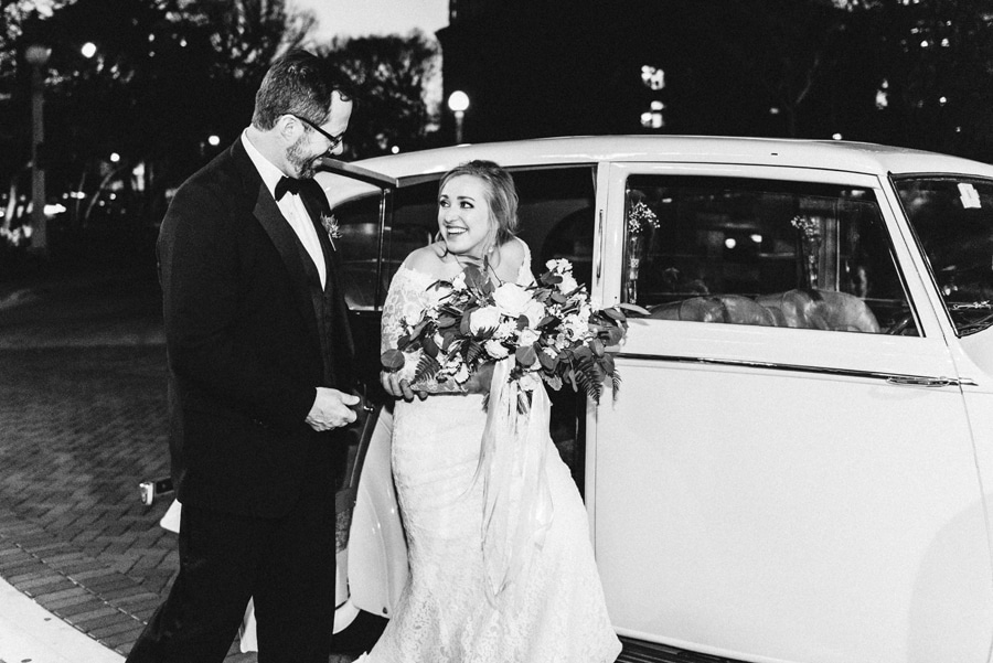 A bride pulls up to her wedding ceremony in a vintage Rolls-Royce.