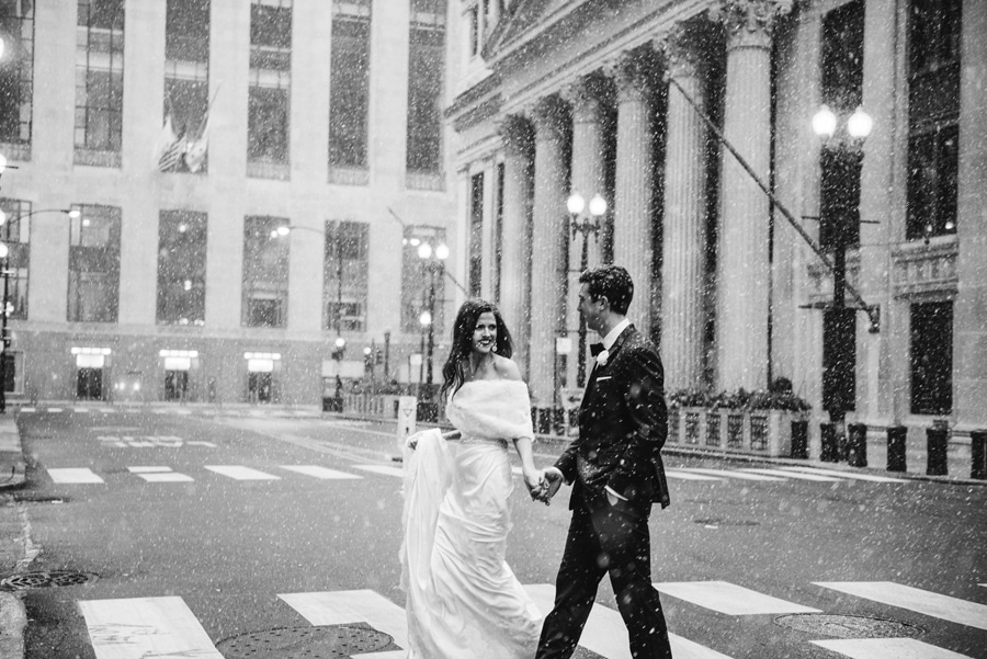 A black and white wedding portrait during a snow storm in Chicago.