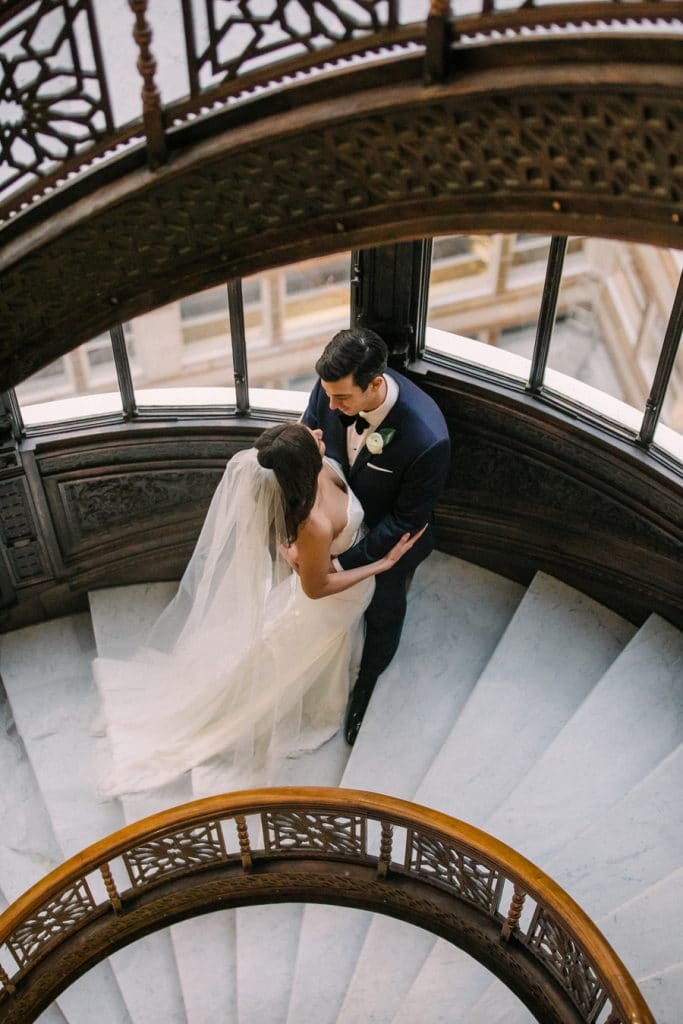 A wedding portrait on the iconic Orielle staircase at the Rookery in Chicago.