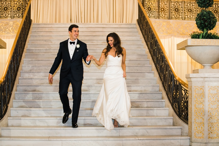 The bride and groom make their grand entrance into the Rookery ballroom for their wedding reception.
