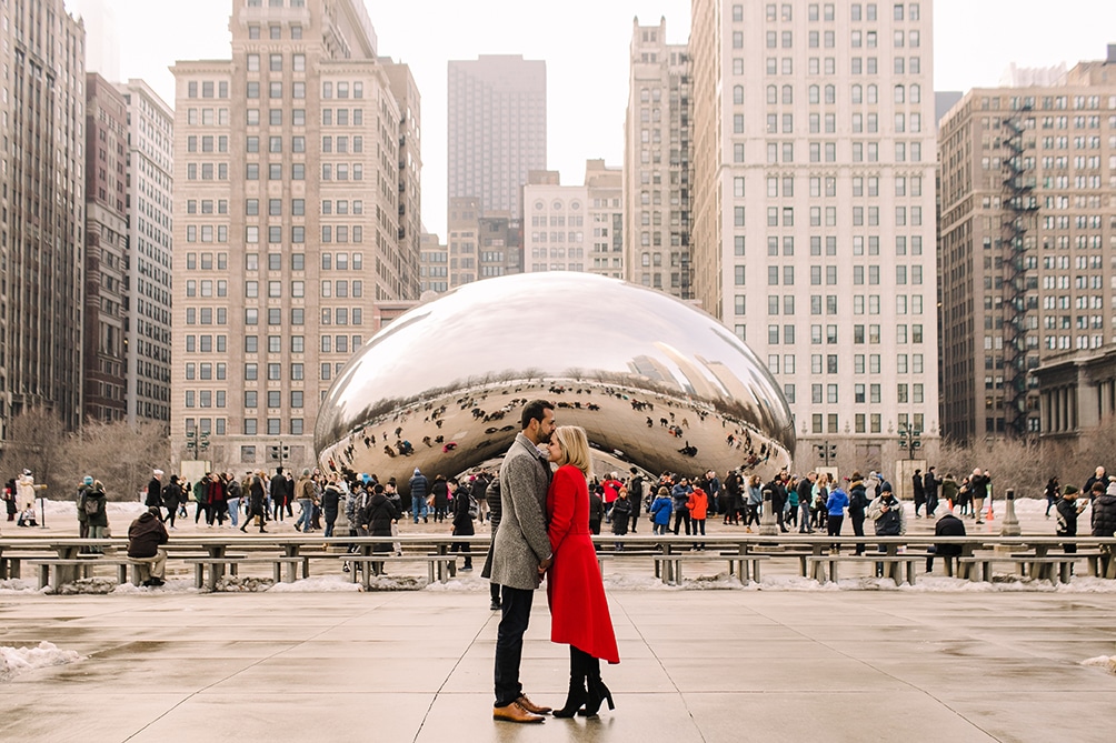 A winter Chicago engagement photo in front of the iconic Bean in Millennium Park