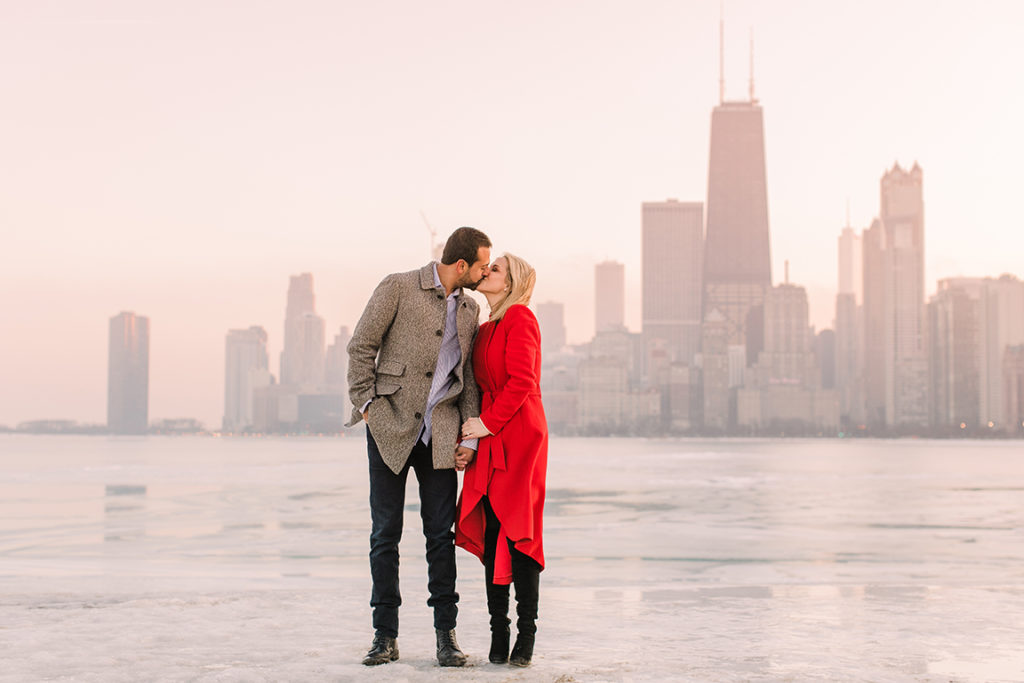 Winter engagement photo in Chicago by Lake Michigan with the skyline in the background.