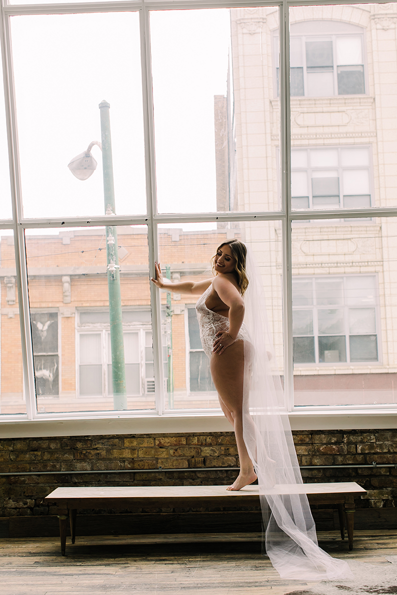 A wedding veil bridal boudoir photo taken at a Parisian styled loft in Chicago