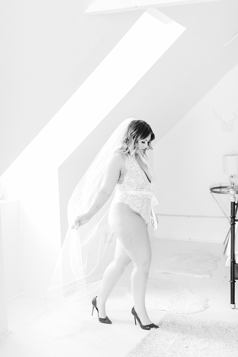 A black and white boudoir photo taken in a Parisian styled loft in Chicago.
