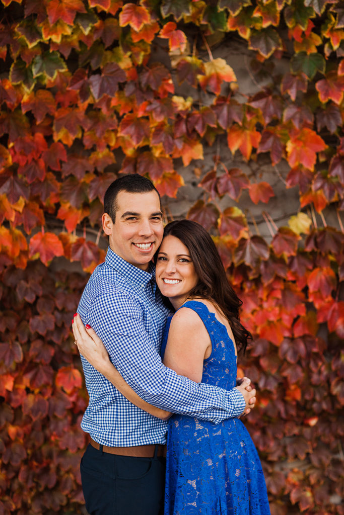 Bride and groom pose in front of fall foliage in Chicago