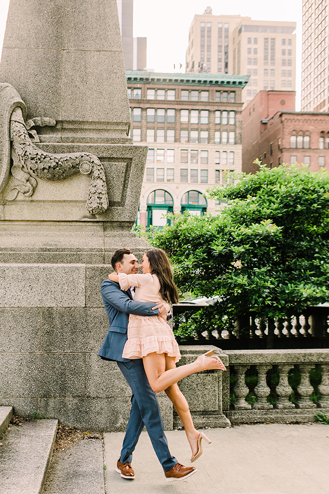 Couple embrace in downtown Chicago for engagement photo