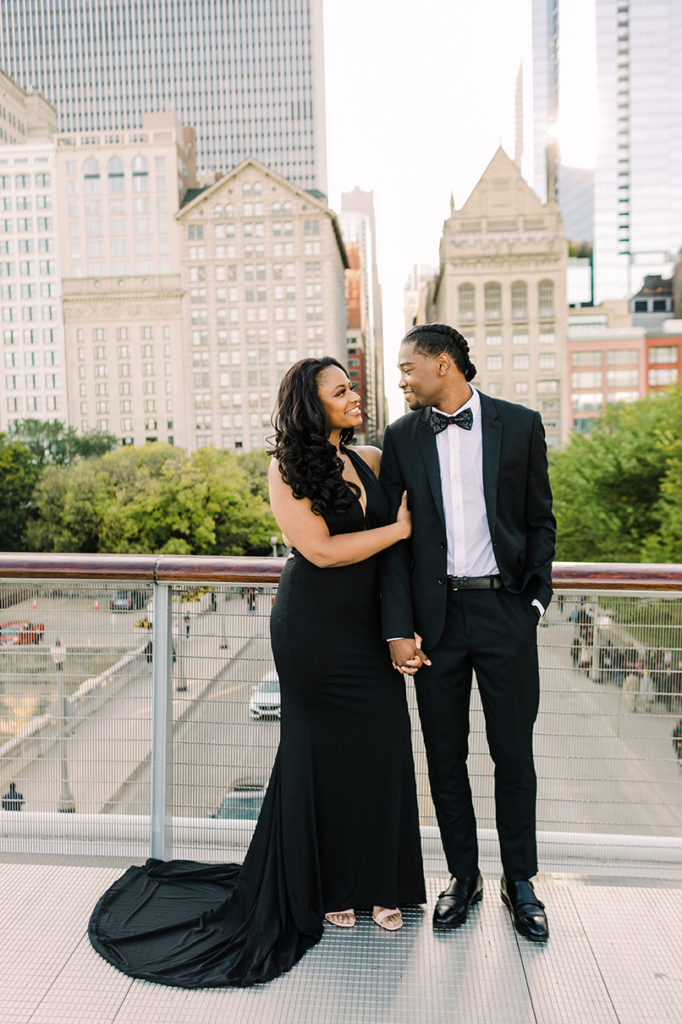 Engaged couple pose in downtown Chicago for engagement photo.