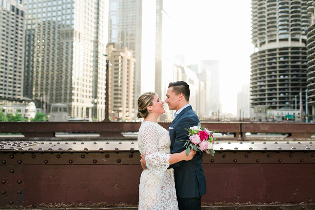 Couple pose on the Clark Street Bridge in downtown Chicago