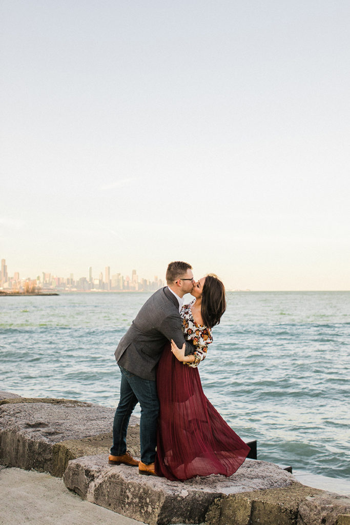 Couple pose in front of Chicago skyline an Promontory Point