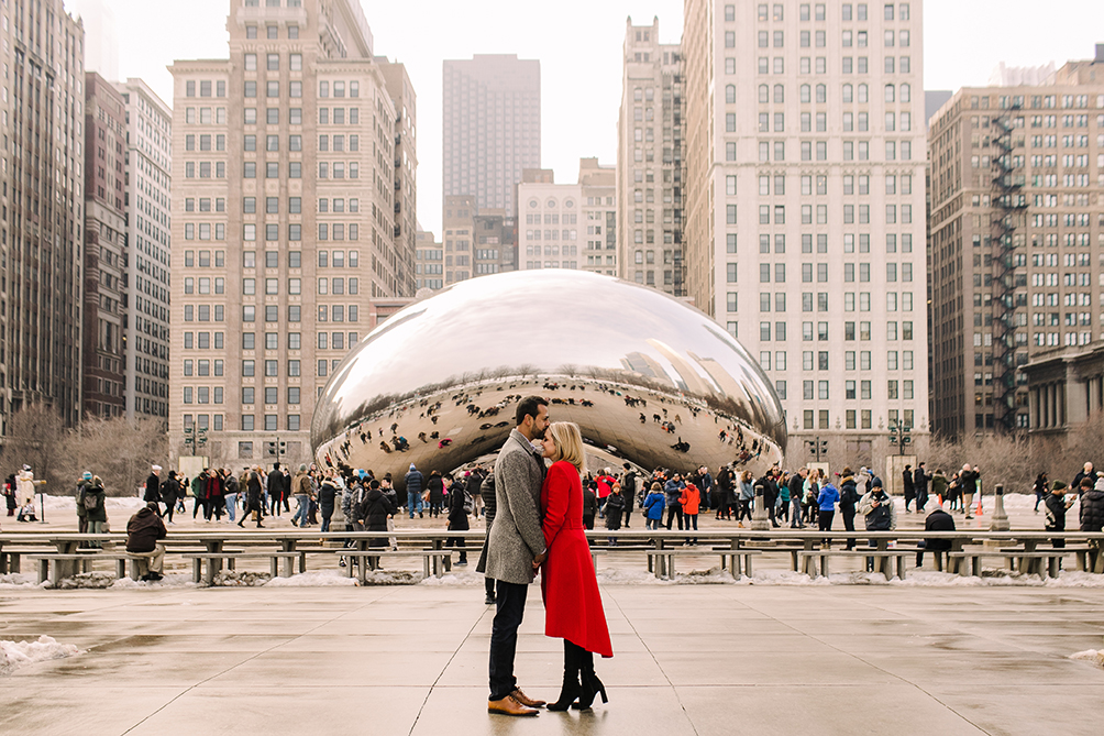 Engaged couple pose in front of the Bean in downtown Chicago