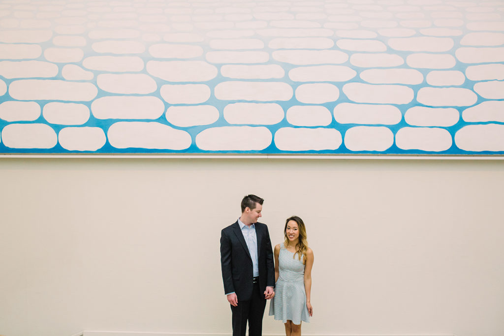 Engagement photo at the Art Institute of Chicago in front of Georgia O'Keeffe's Sky Above Clouds painting.