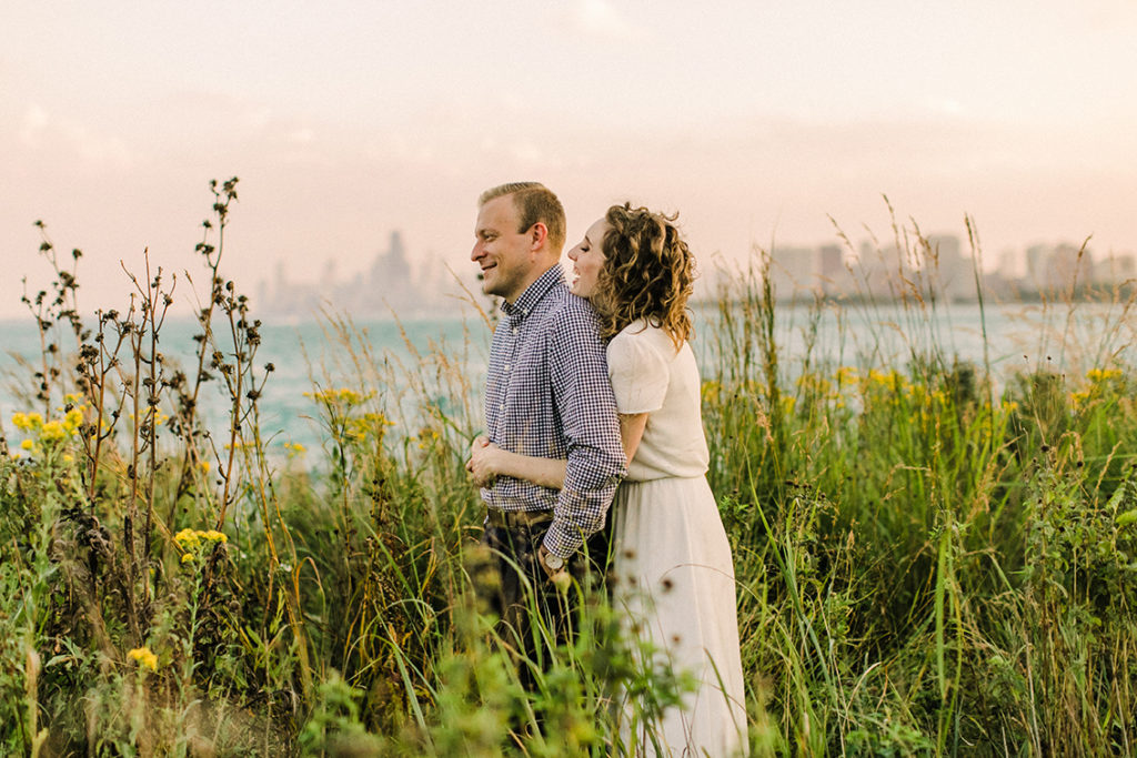 Engaged couple pose at Montrose Harbor for engagement photo in Chicago