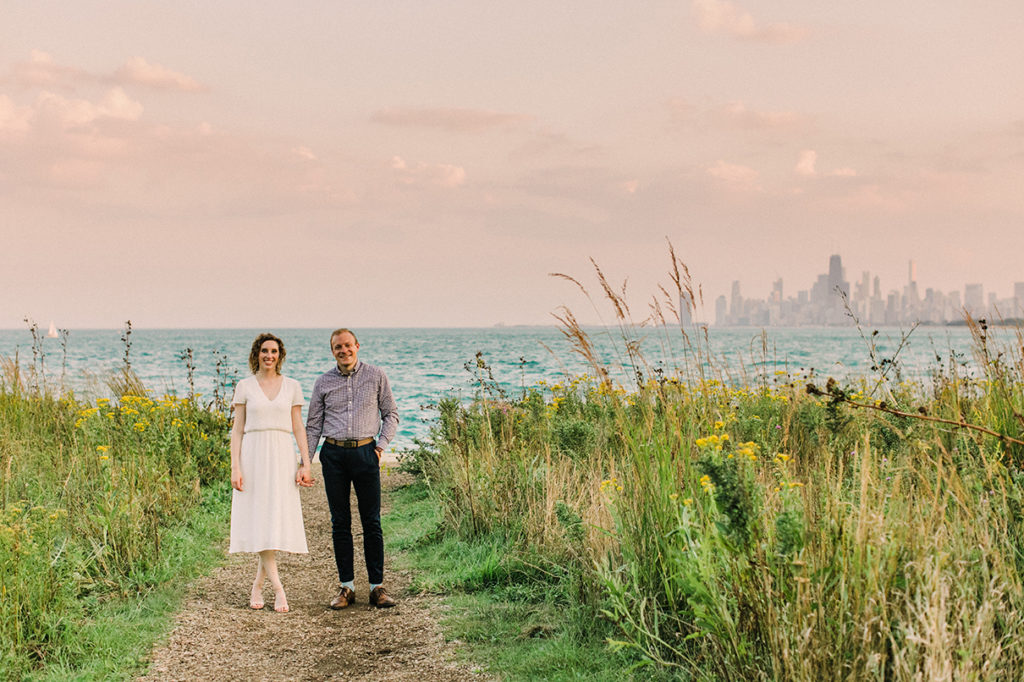 Couple pose at Montrose Harbor for engagement photo