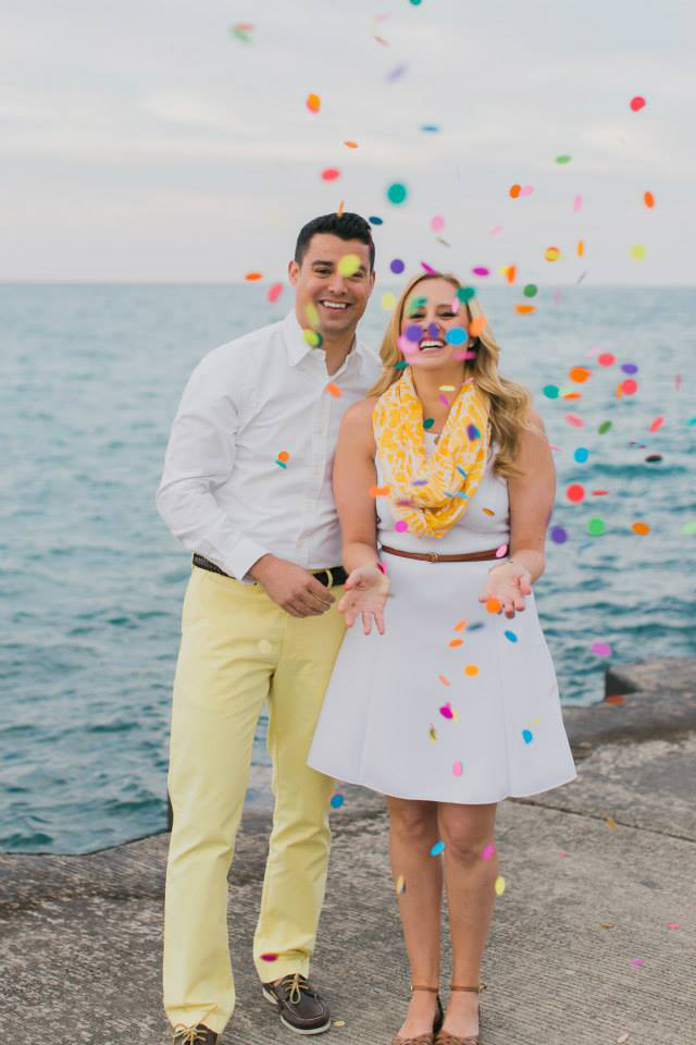 Couple tosses confetti in the air in front of Chicago lakefront for engagement photo