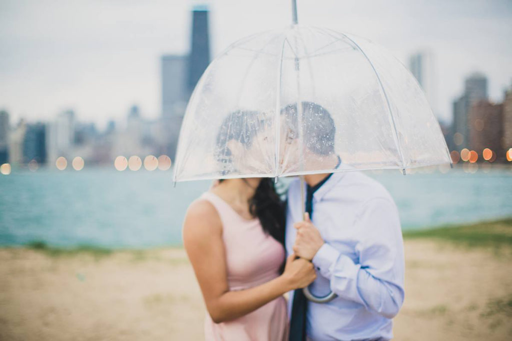 Engagement photo in the rain at North Avenue Beach