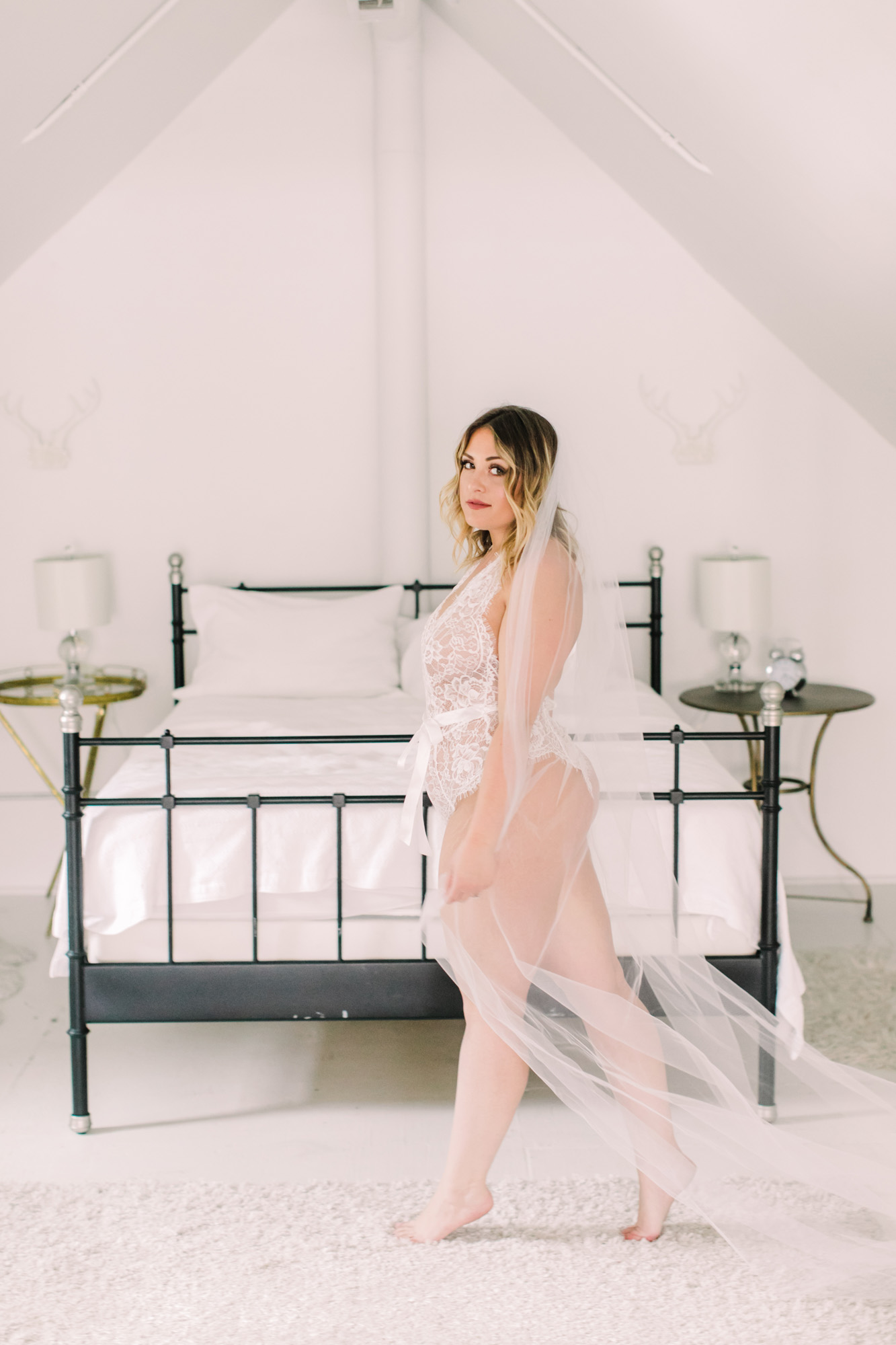 A true bridal boudoir session done with a cathedral length wedding veil.