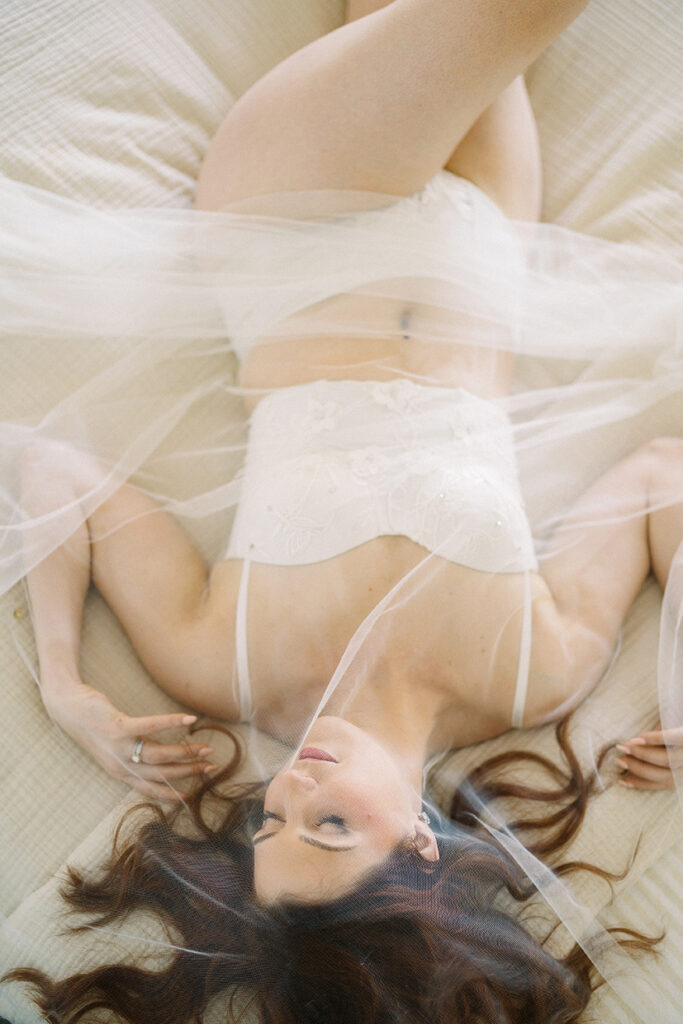 A bridal boudoir photo using a wedding veil