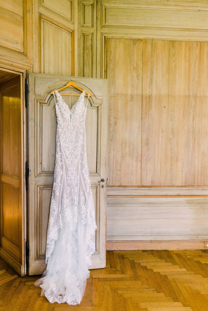 Wedding dress hangs in the bridal suite at Chateau De La Hulpe