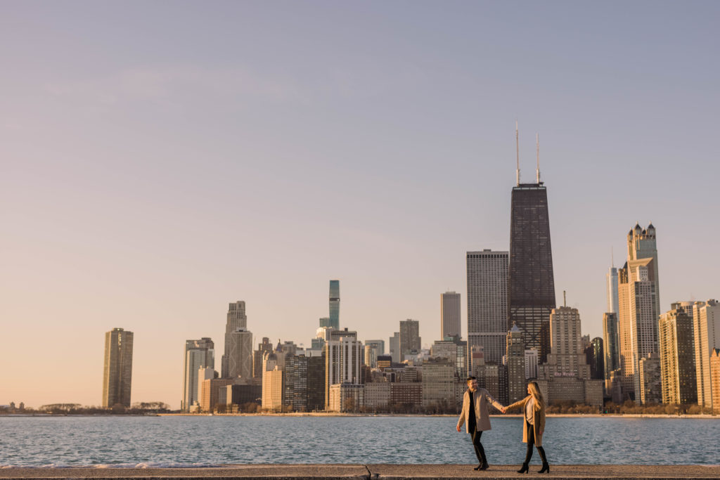 Walking along the lakefront at North Avenue Beach with the Chicago skyline in the backdrop.