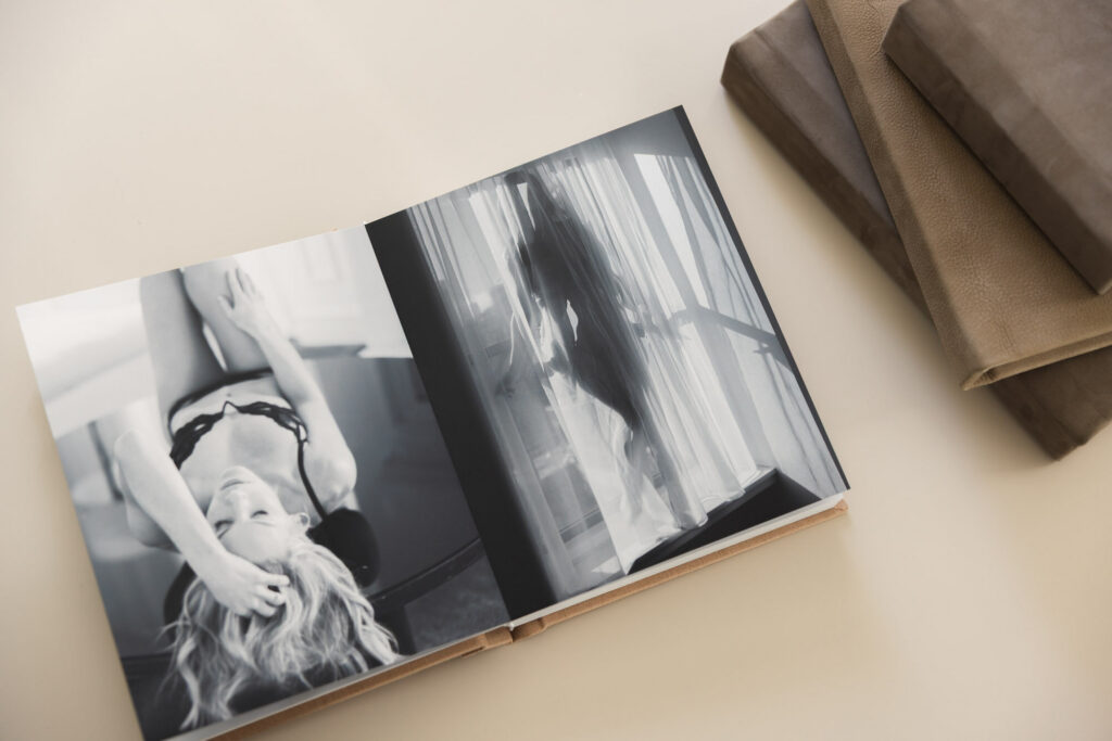 Fine art boudoir album with black and white images displayed on a table