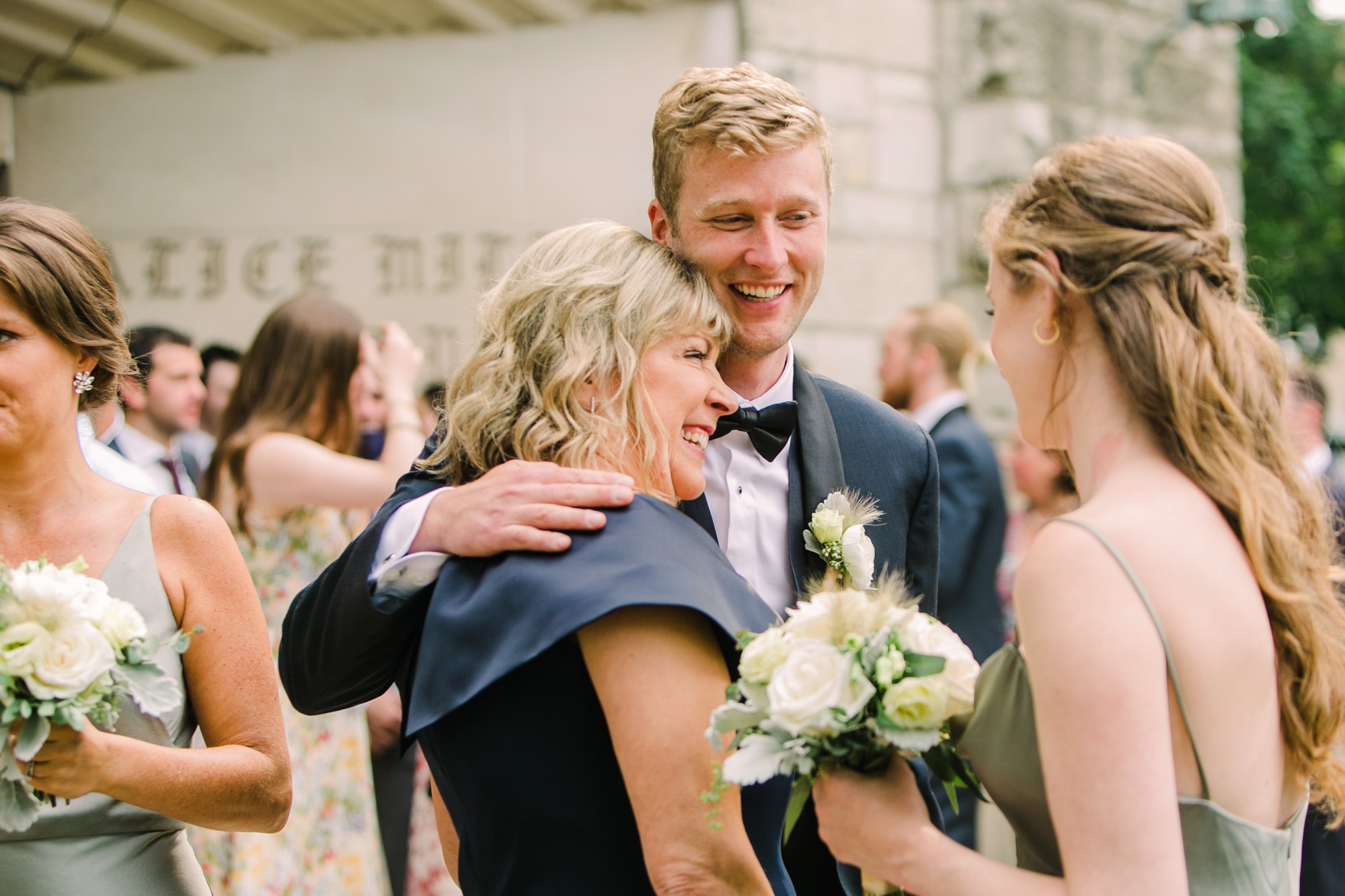 A groom hugs his mom after getting married at a wedding ceremony in Evanston, IL.