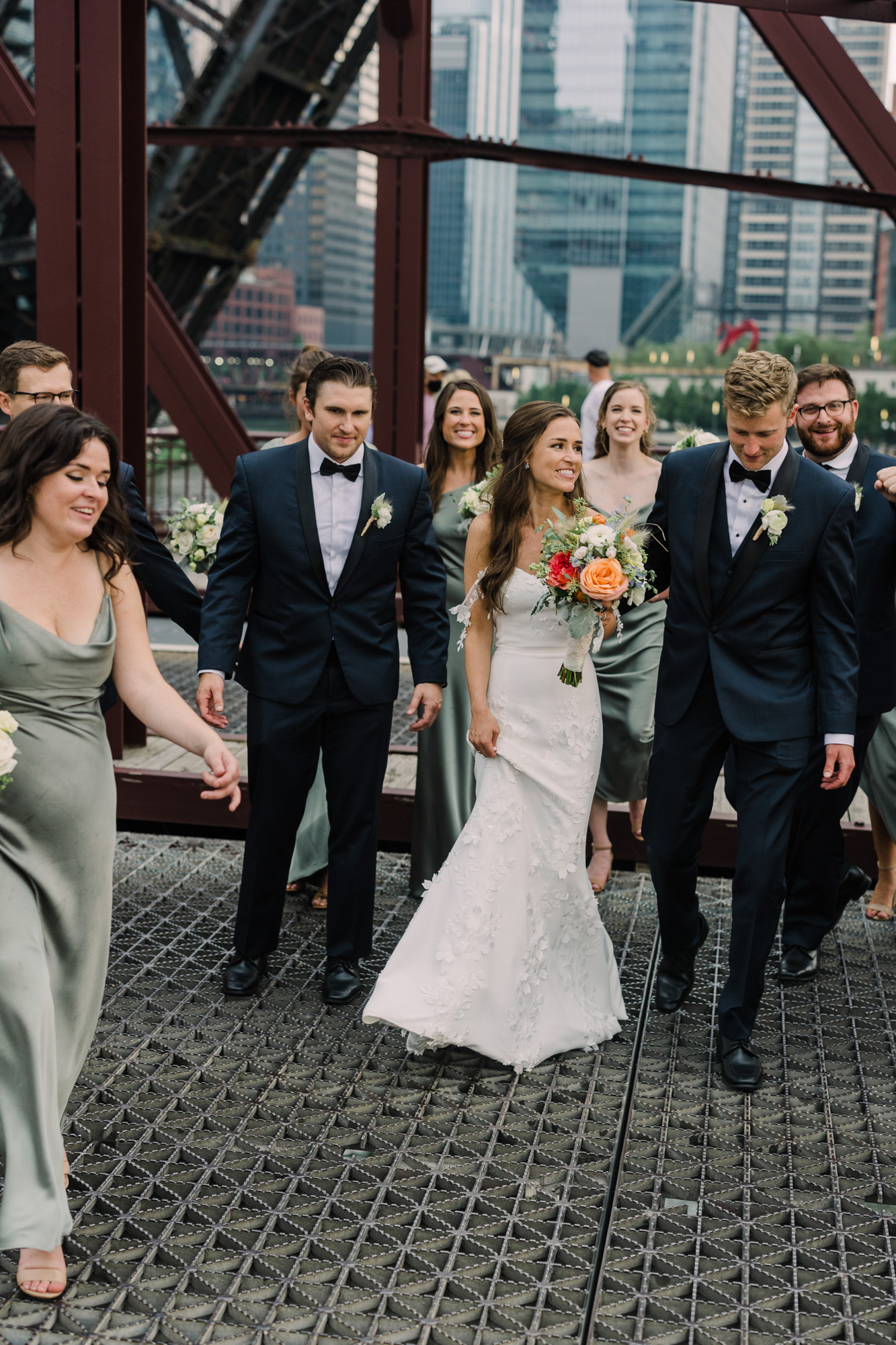 Wedding party pose on the Kinzie Street Bridge in Chicago's West Loop for a portrait.
