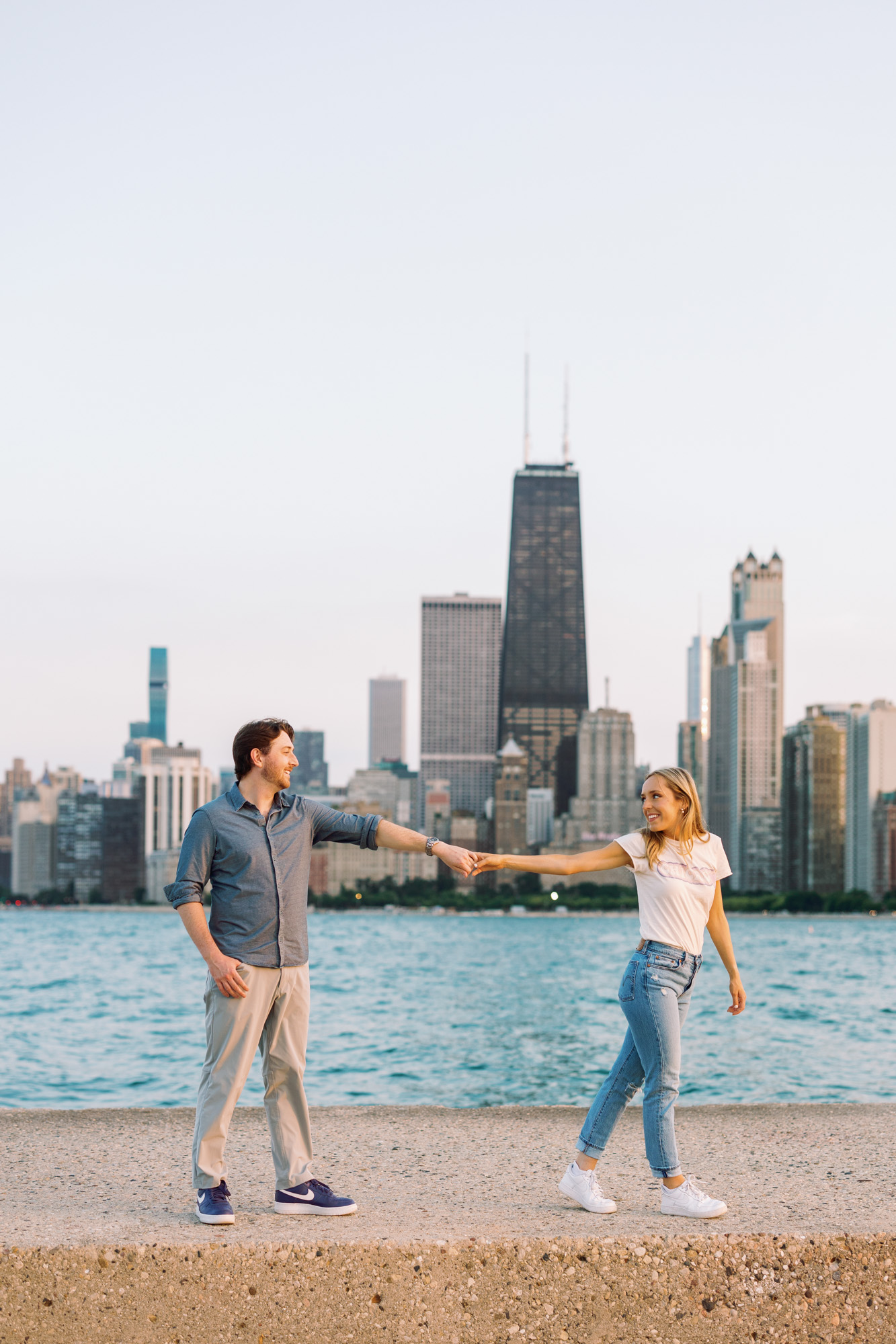An engaged couple takes a stroll along the lakefront in Chicago.