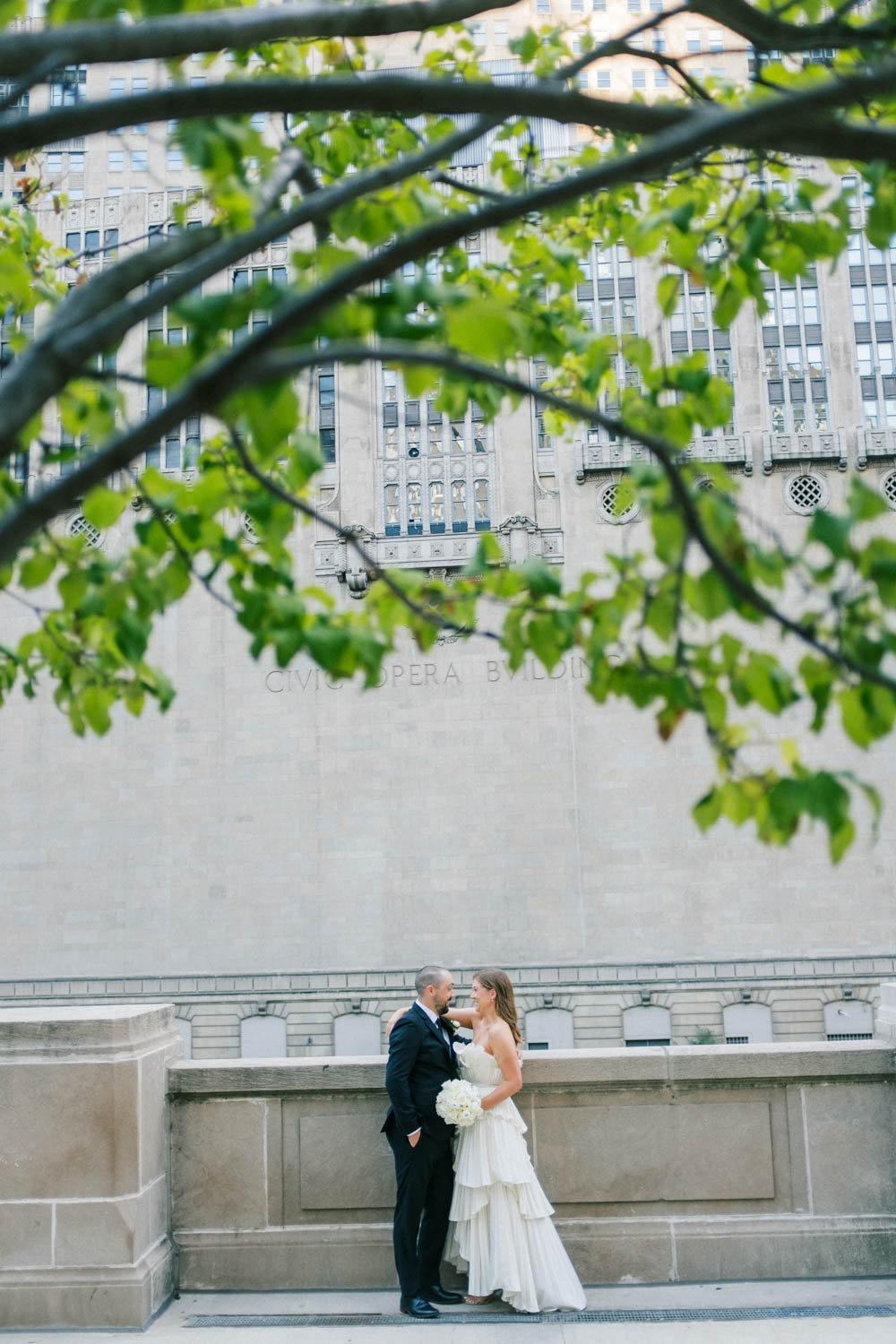 A wedding portrait with mix of greenery and city in downtown Chicago