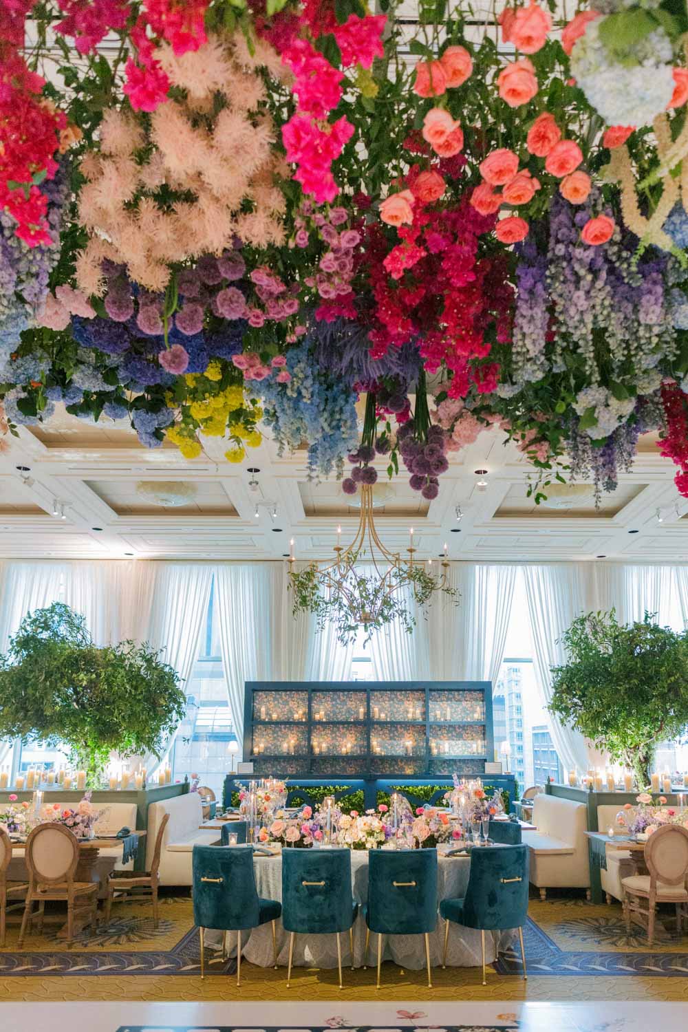Colorful wedding flowers drape from the ceiling of The Peninsula hotel in Chicago.