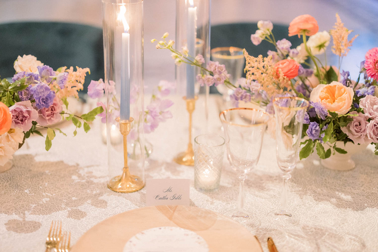 A romantic colorful wedding reception with blue tapered candles.