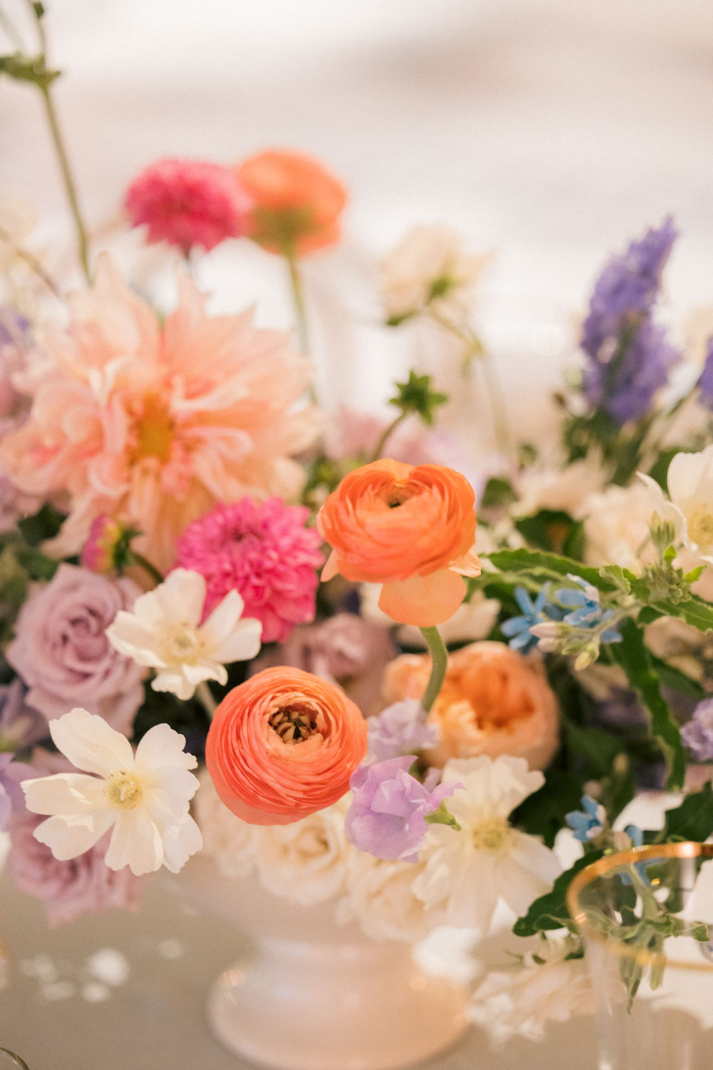 A summery, colorful wedding reception floral arrangement.