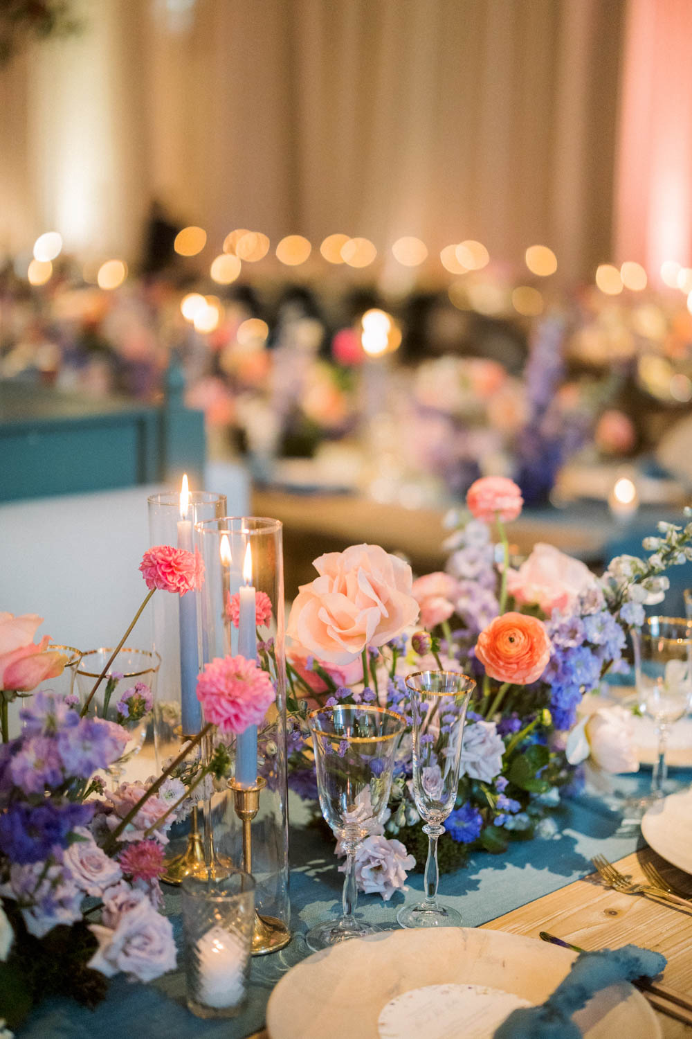 Colorful floral arrangements and candlelight at a wedding hosted at the Peninsula in Chicago.