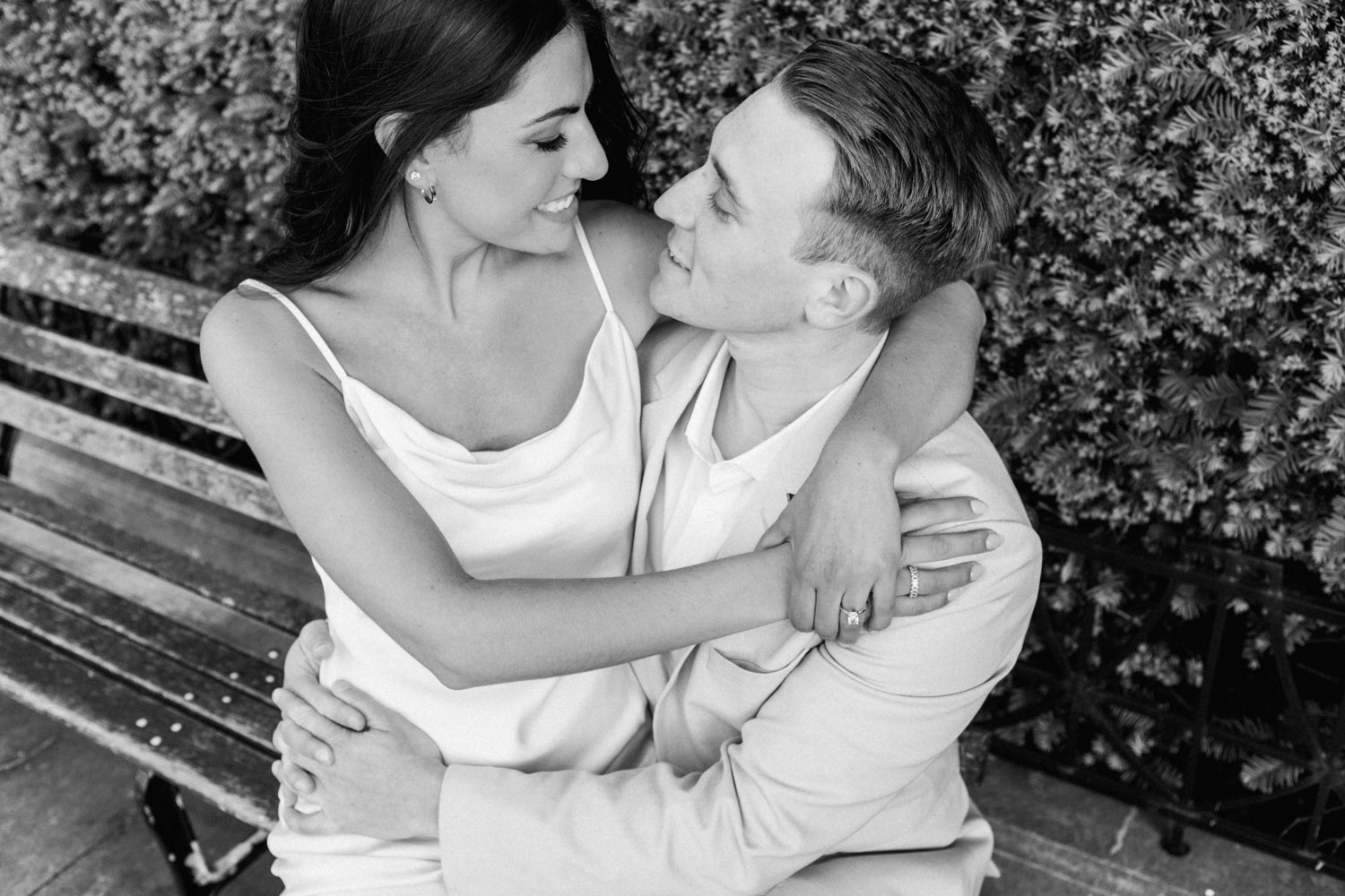 A black and white engagement photo in a downtown Chicago garden