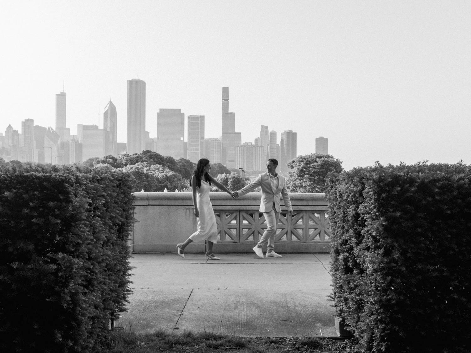 A unique black and white engagement photo featuring the Chicago skyline