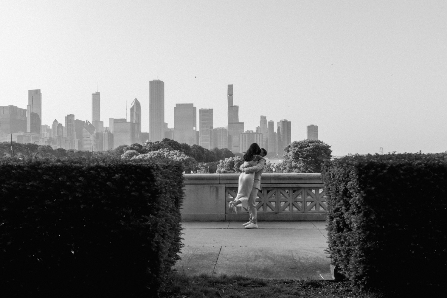 A unique black and white engagement photo featuring the Chicago skyline