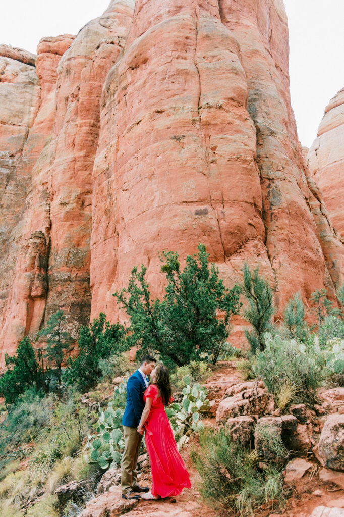 A couple share a kiss at the top of Cathedral Rock