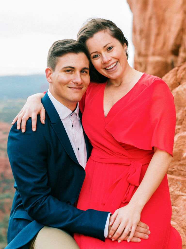 A couple smile for the camera as they take engagement photos in Sedona