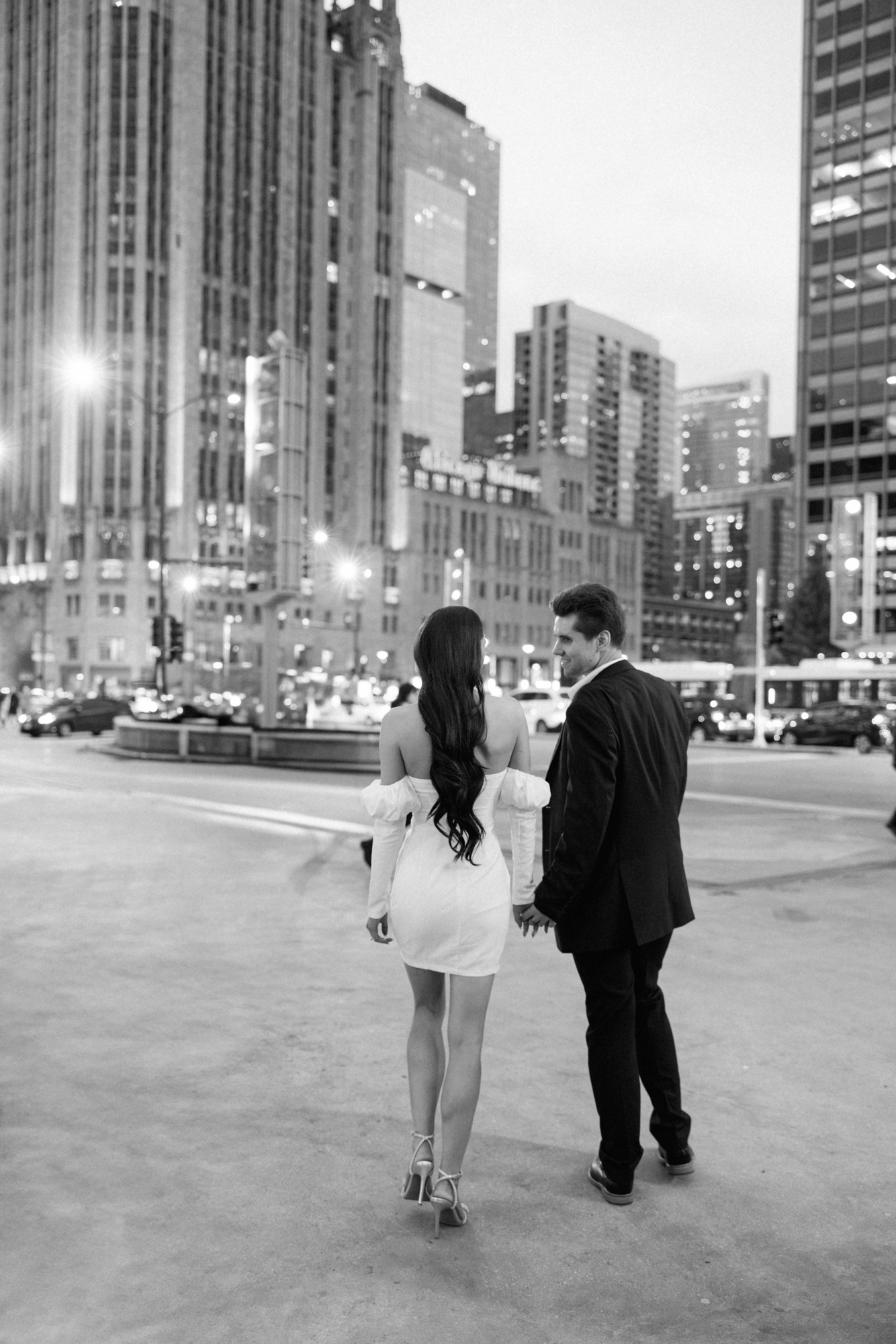 An engagement photo taken at dusk along Michigan Avenue in downtown Chicago