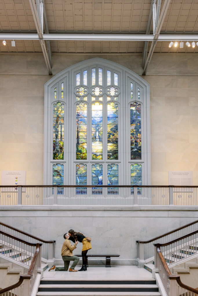 Marriage proposal at The Art Institute of Chicago with the groom-to-be down on one knee
