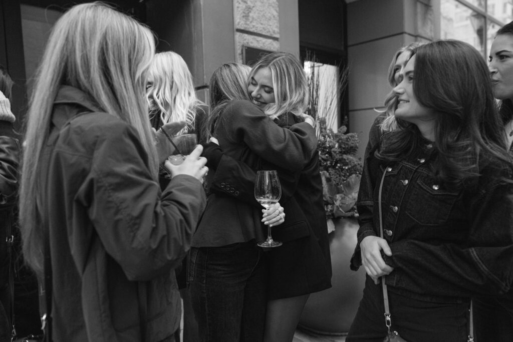 Group of friends smiling and celebrating at engagement party in downtown Chicago.