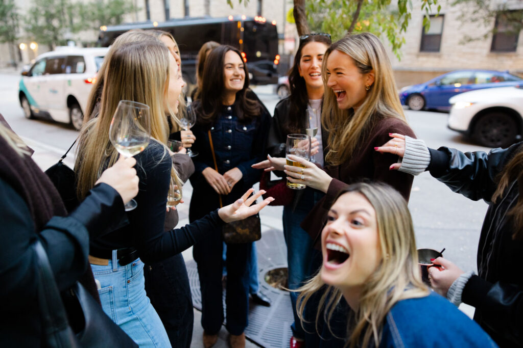 Group of friends smiling and celebrating at engagement party in downtown Chicago.