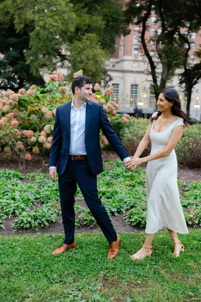 Couple walking through formal garden along Michigan Avenue in Chicago