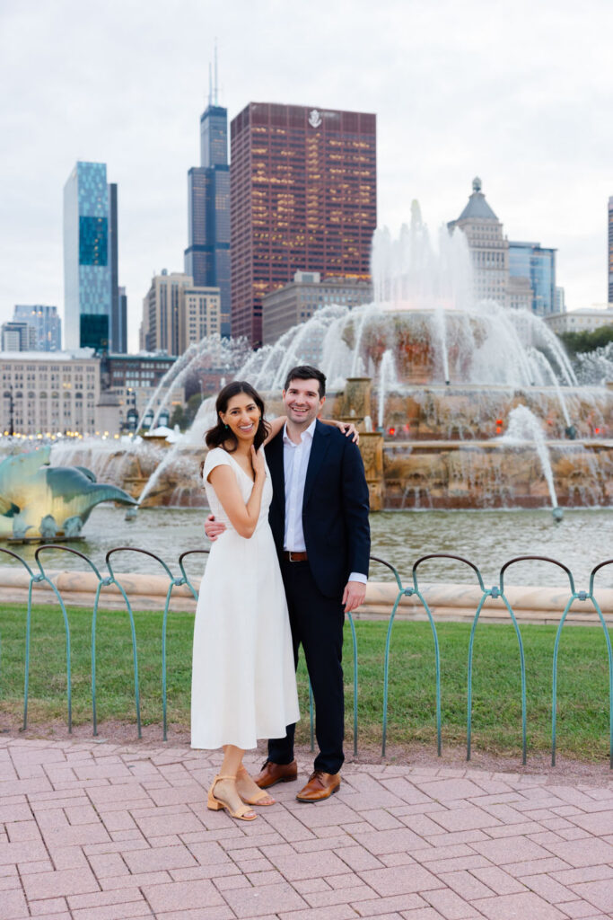 Couple standing together at Buckingham Fountain during Chicago engagement session