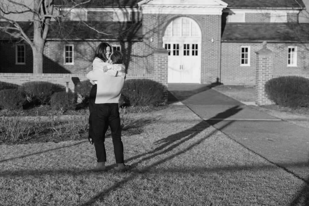 Black and white photo of couple spinning in front of Elawa Farm building